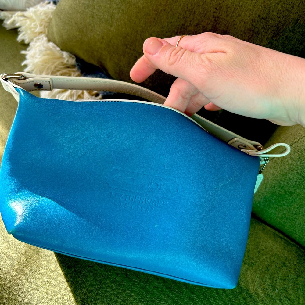 Small blue vintage Coach handbag perfect for outings and casual use